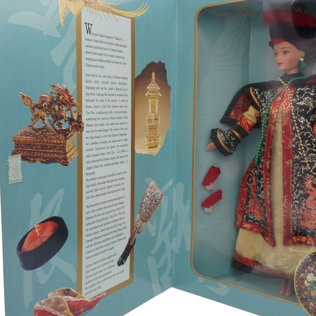 Doll in a decorative box with intricate clothing and accessories