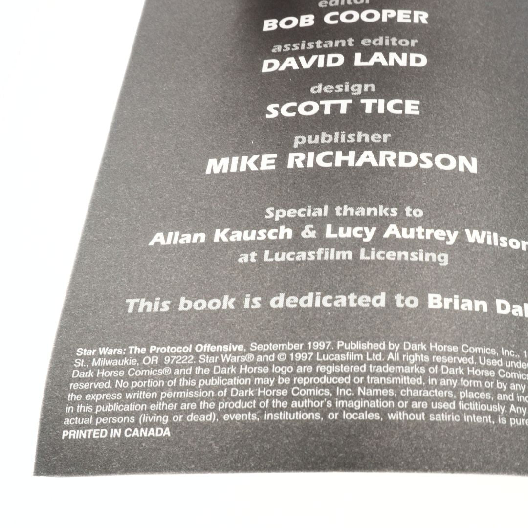 Back cover of a book with text including author names and dedications on a gray background