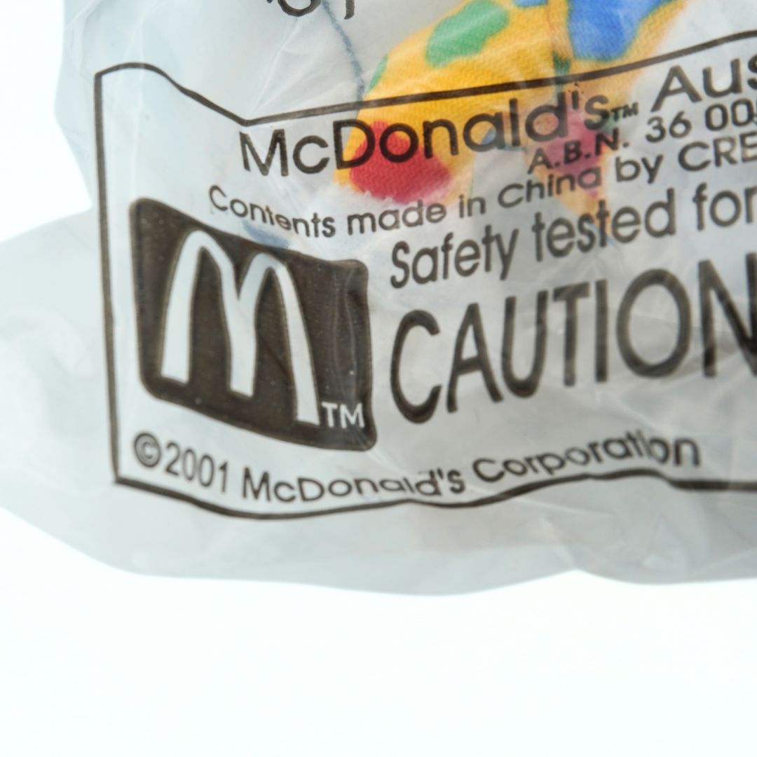 Close-up of a McDonald's toy packaging label with branding and safety information.