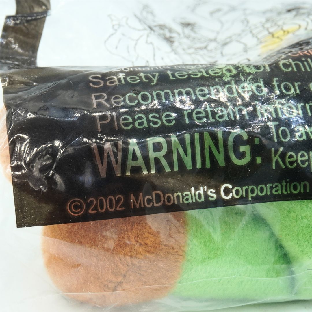 Close-up of a McDonald's toy packaging with a warning label.