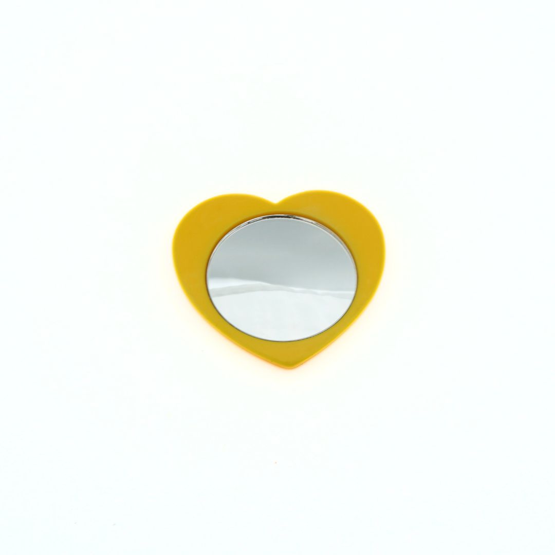 Heart-shaped mirror with a yellow colour palette