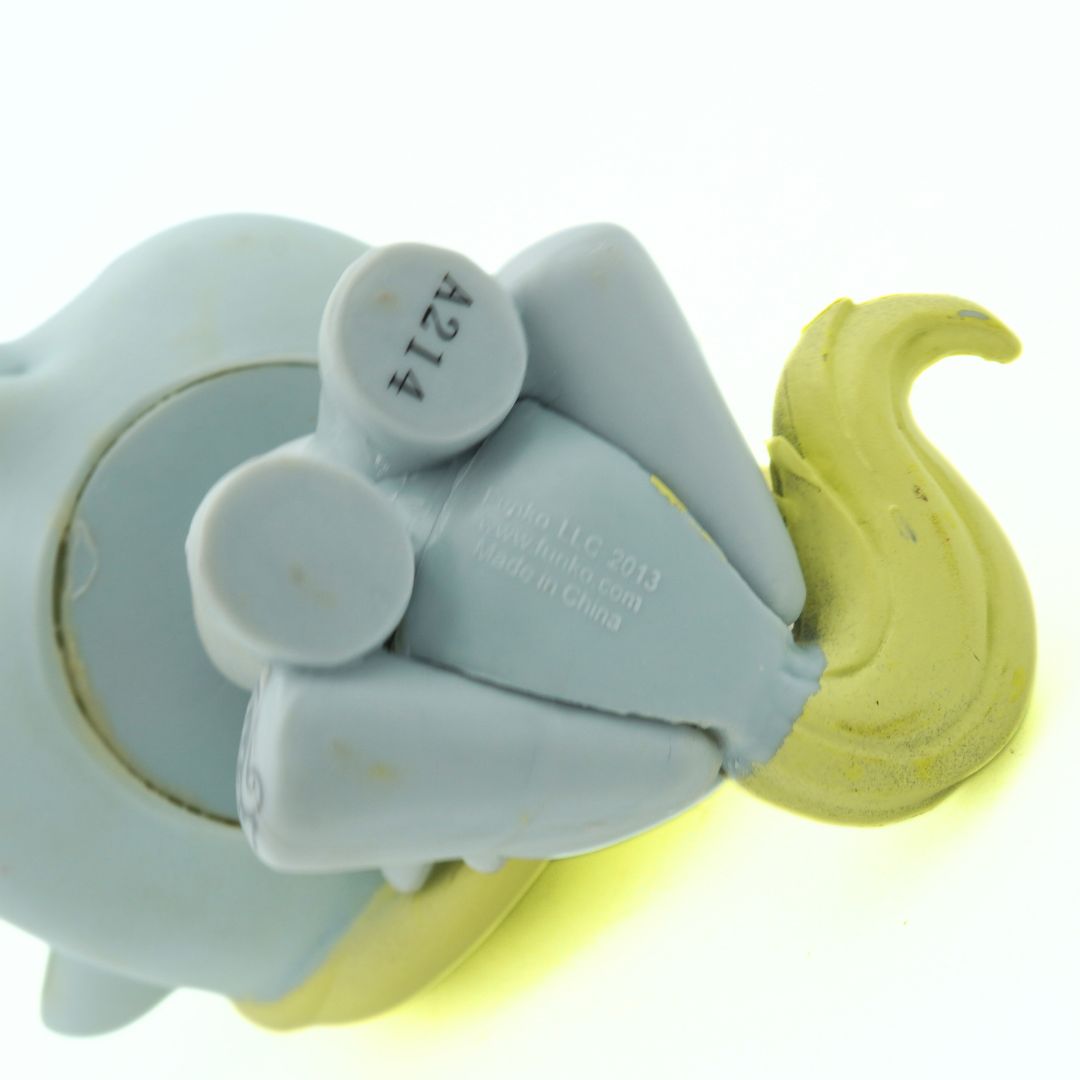 Gray toy with yellow hair on a white background