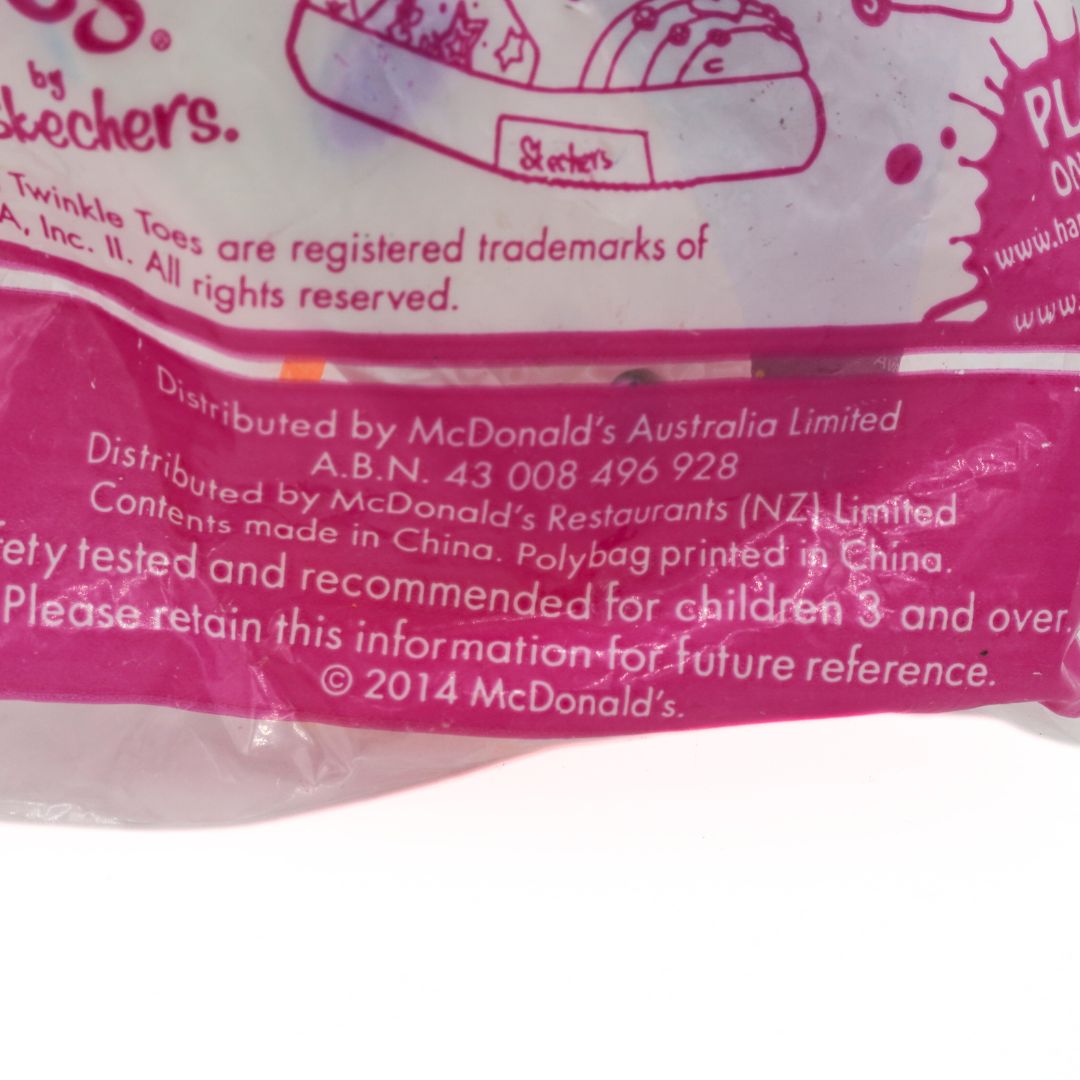 Close-up of a pink package with text and branding, including McDonald's and Skechers logos.