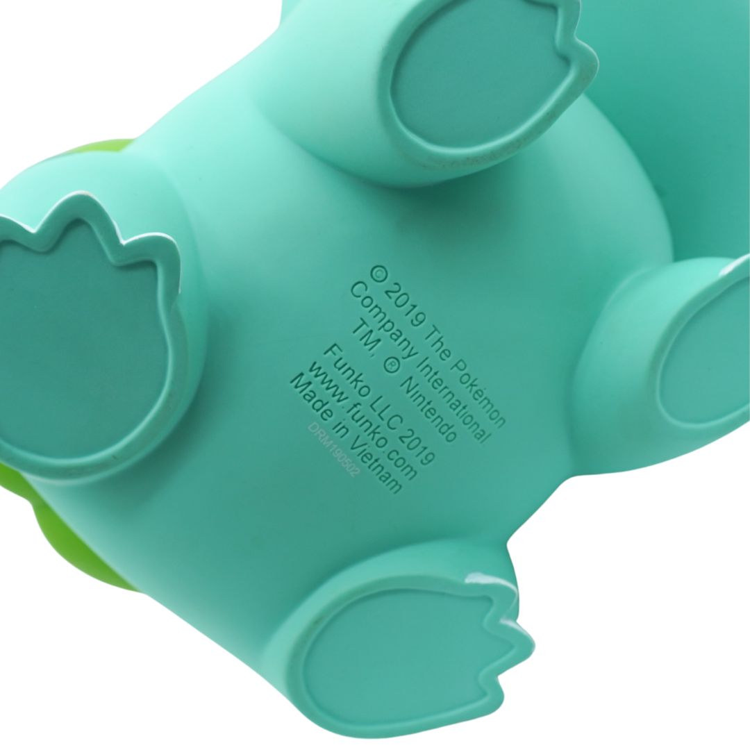 Teal and green toy figure on a white background