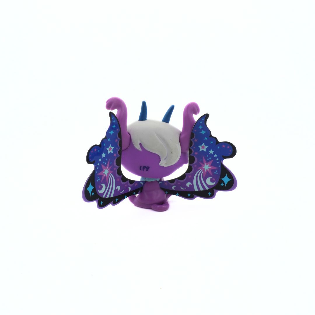 Purple figurine with butterfly wings on a white background