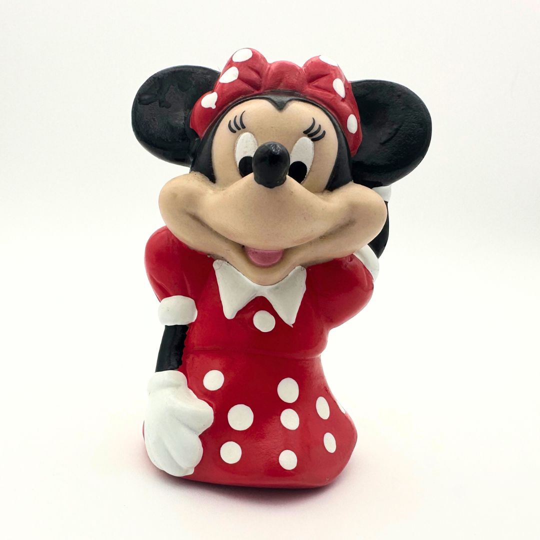 Front on photo of a vintage Minnie Mouse figure in a red dress