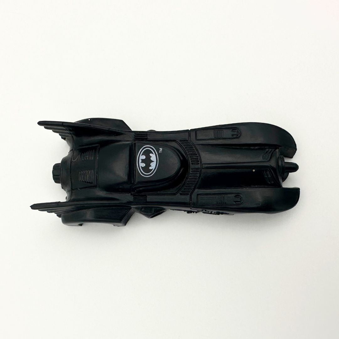 A top down photo of a vintage Batman Batmobile toy