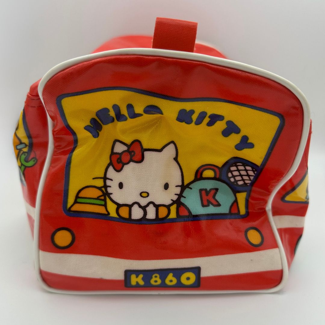 Side on image of a 70s vintage Sanrio Hello Kitty bag shaped like a school bus