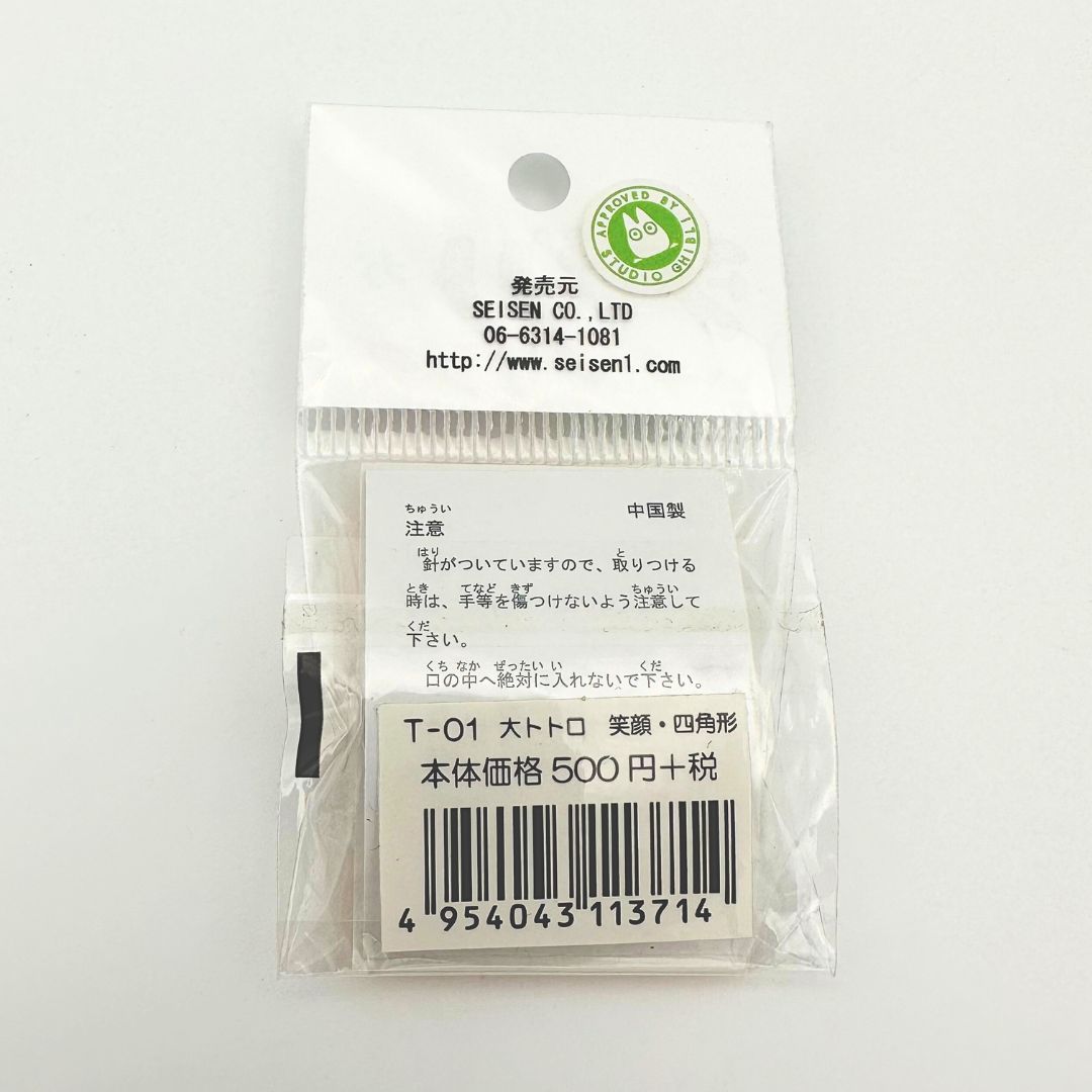 The back of a Studio Ghibli Totoro pin stored inside plastic packaging with its barcode on display