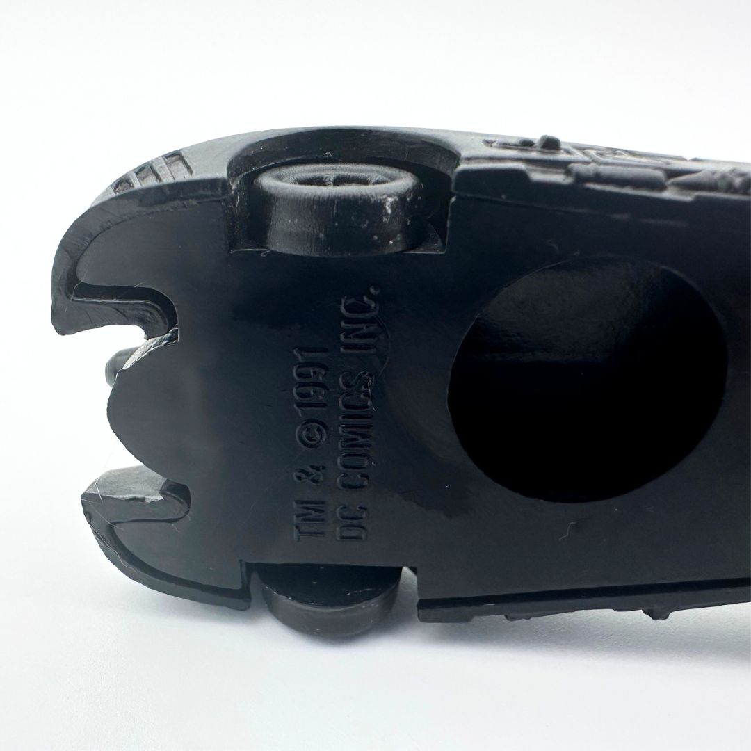The branding of a 1991 Batman Batmobile toy car