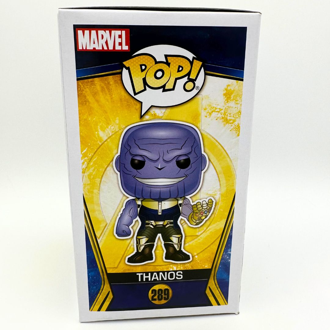 A photo of the side of the 289 Thanos Pop Vinyl Funko Pop box featuring an illustration of the character on a gold background