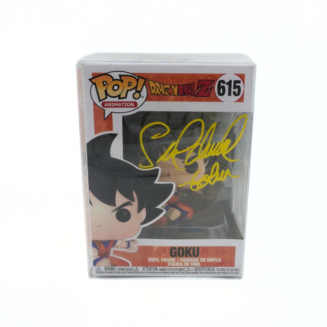 Funko Pop! Goku figure in packaging with signature on a white background