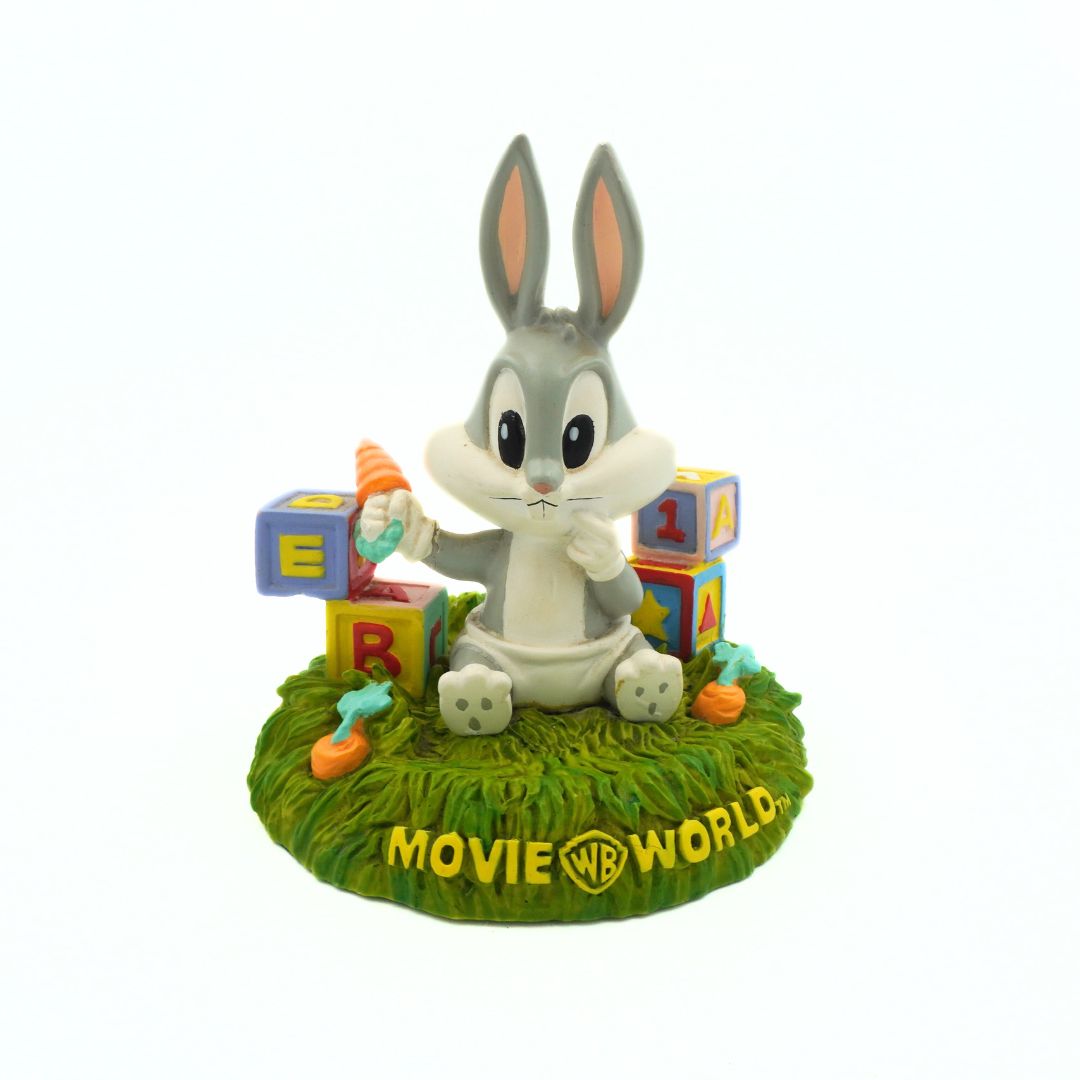 Animated character figurine with colorful blocks and grass base, featuring 'Movie World' branding.