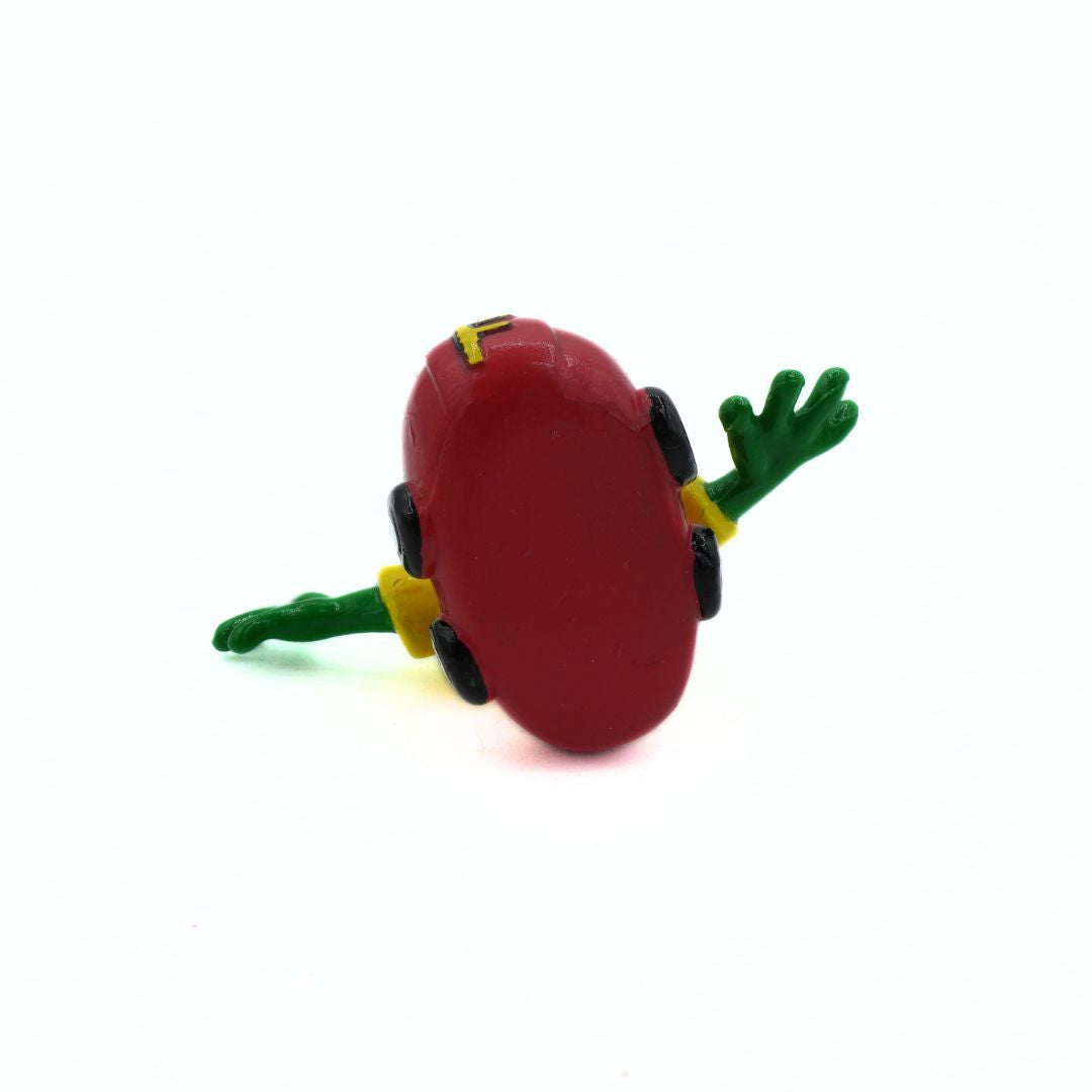 Red toy frog with green legs on a white background