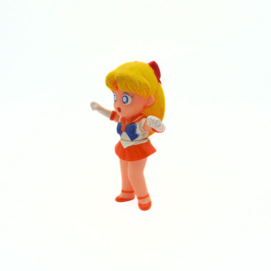 A 1994 Bandai Sailor Venus figurine with an orange and blue outfit and blonde hair