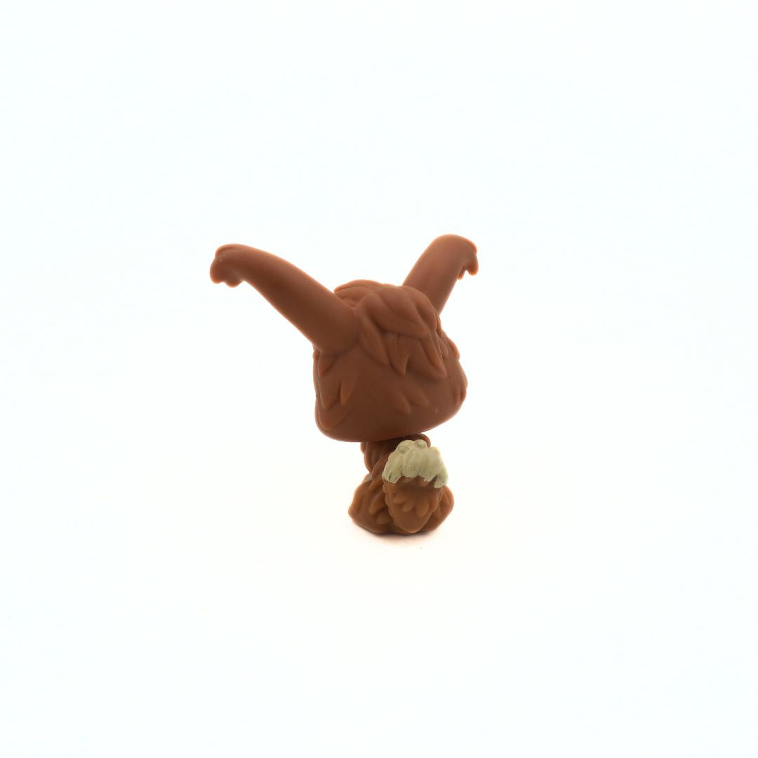 Small brown toy figure on a white background
