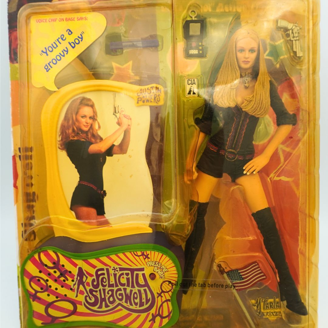 Closeup of a 1999 Austin Powers Felicity Shagwell figurine still in its original packaging with accessories included
