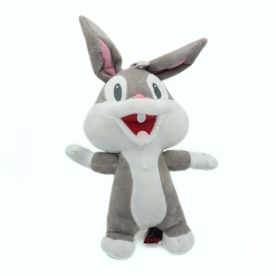 Plush toy of a baby Bugs Bunny plush with gray fur and red mouth on a white background