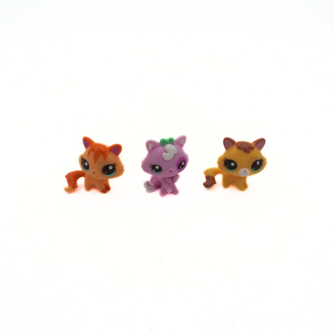 Three small animal figurines on a white background