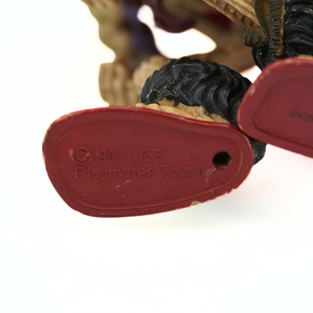 Underside of a 1994 Baron Dark figurine with brand embossing