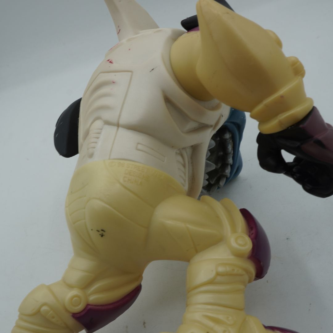 Toy figure with beige and purple colors on a white background