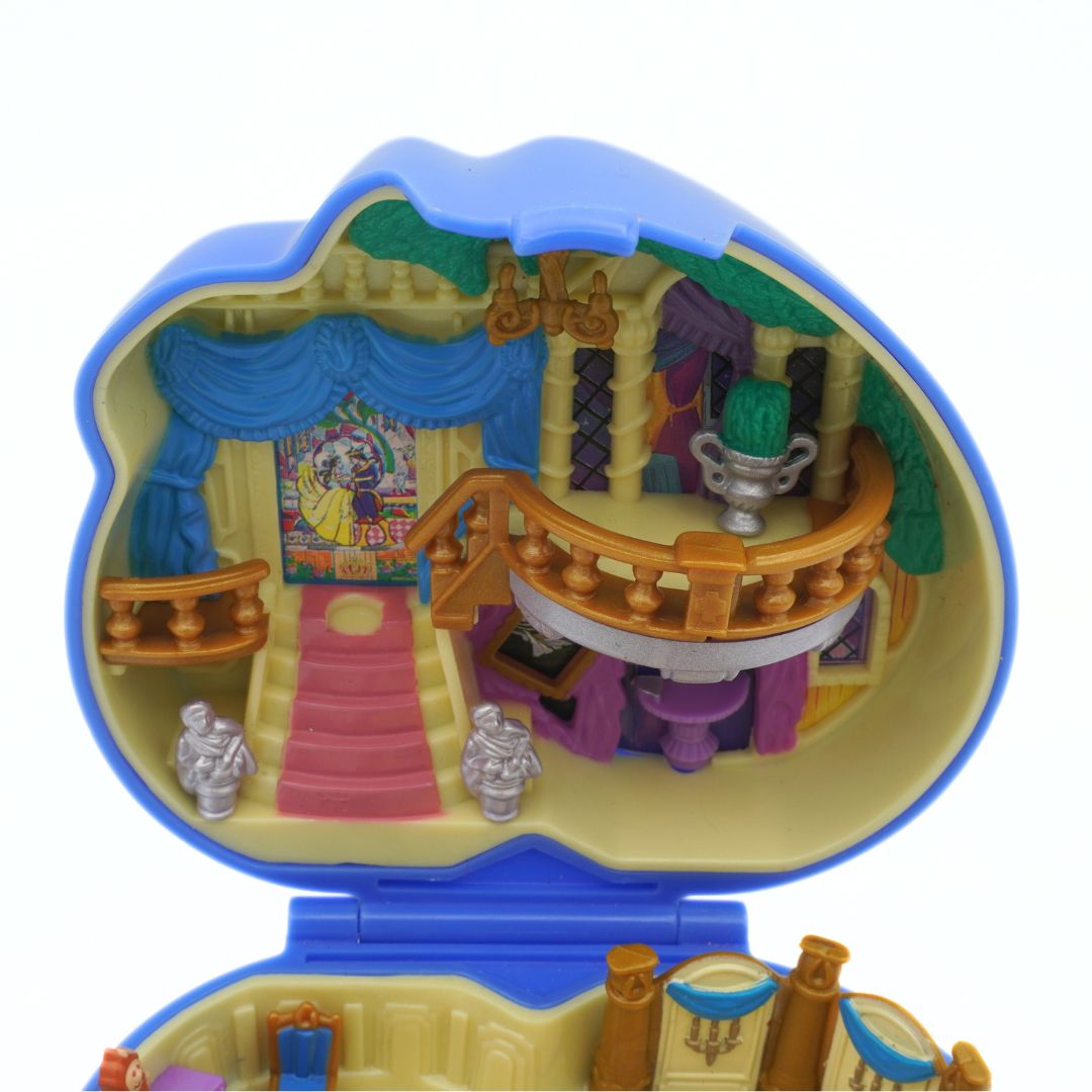 Toy dollhouse with detailed interior on a white background