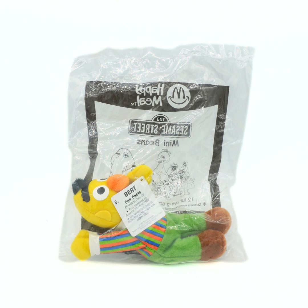 Plush toy in a McDonald's Happy Meal package with Sesame Street branding.