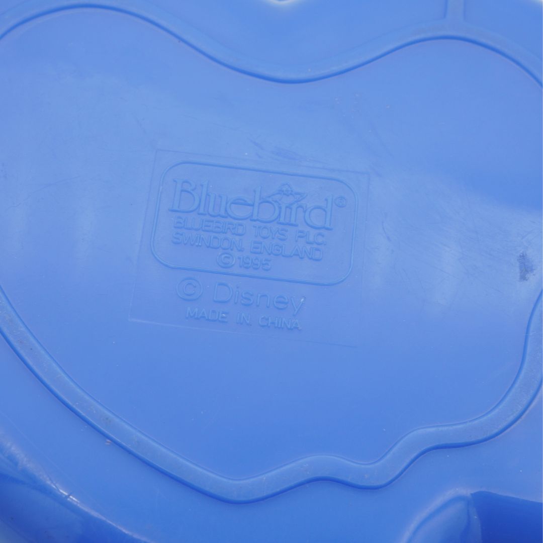 Blue plastic toy with 'Bluebird' and 'Disney' branding on a close-up of the lid.