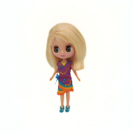 Toy doll with blonde hair and a colorful outfit on a white background