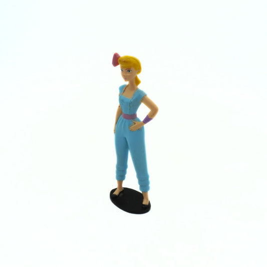 Toy figure of a character with blue outfit on a white background
