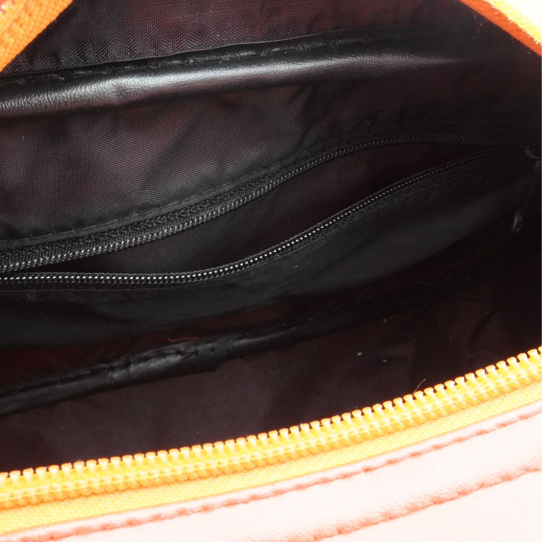 Inside of a vintage Tweety Bird bowling bag showing an internal zip pocket