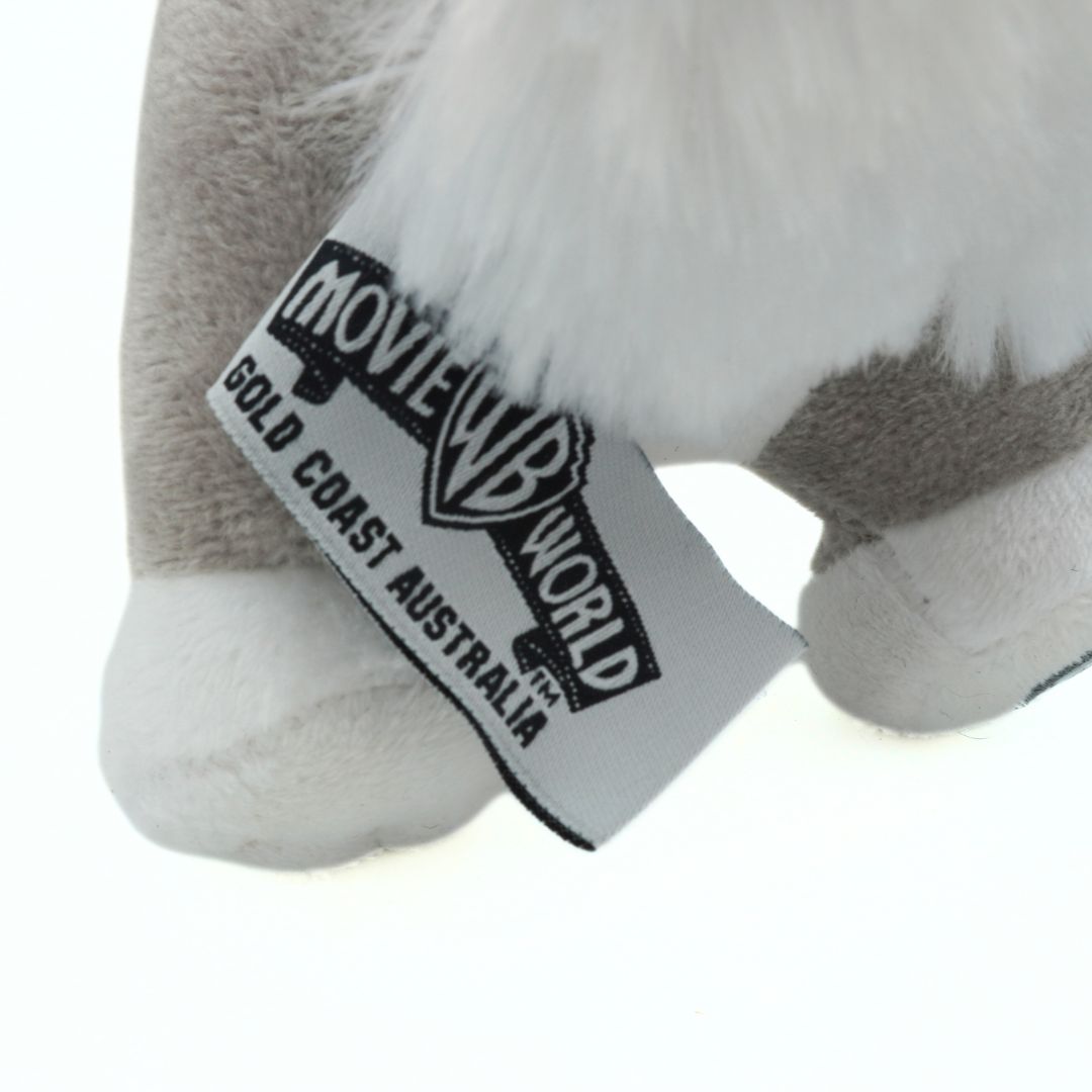 Plush animal toy with a 'Movie World Gold Coast Australia' tag on a white background