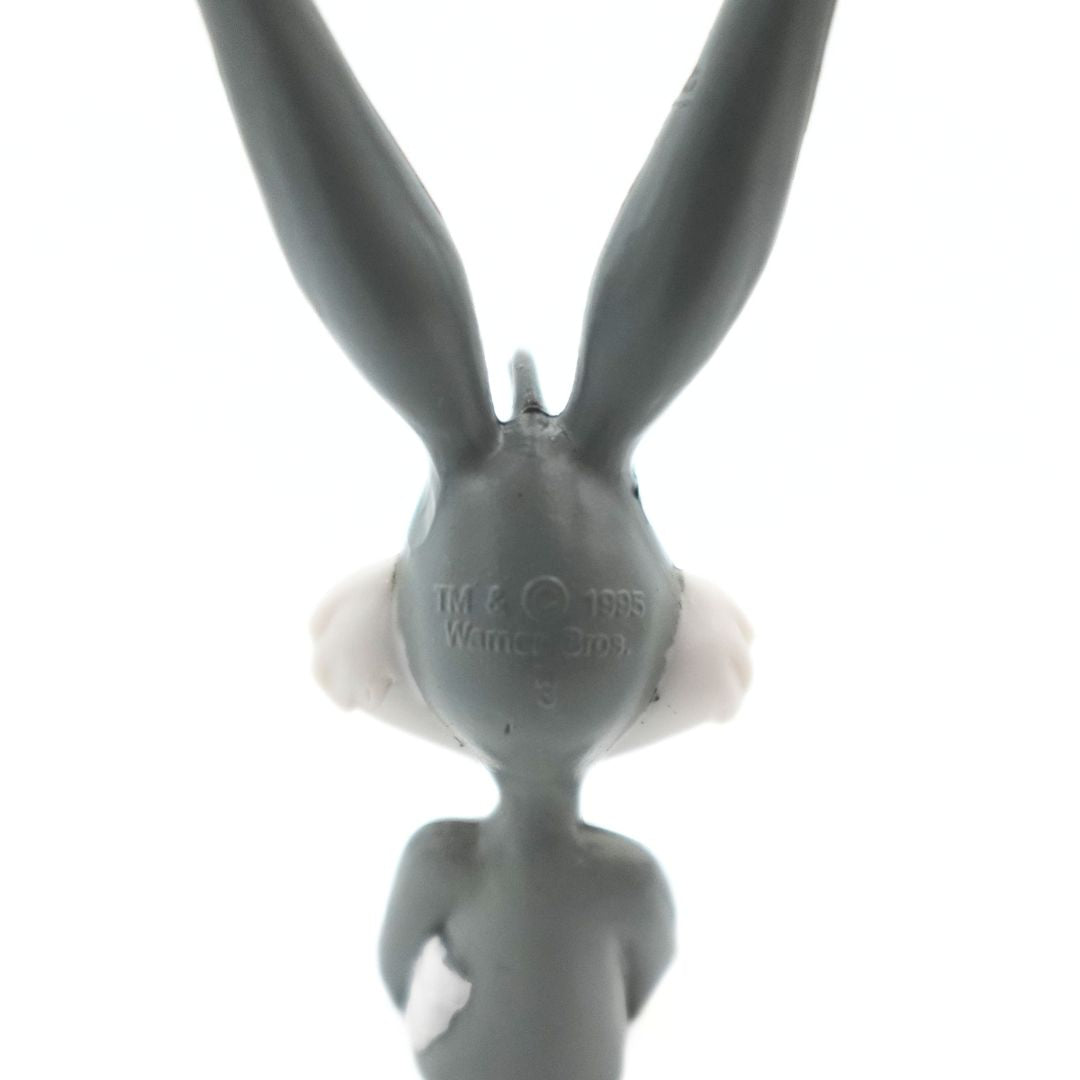 Branding of a 1995 Bugs Bunny Warner Bros half figure with a grey and white colour palette