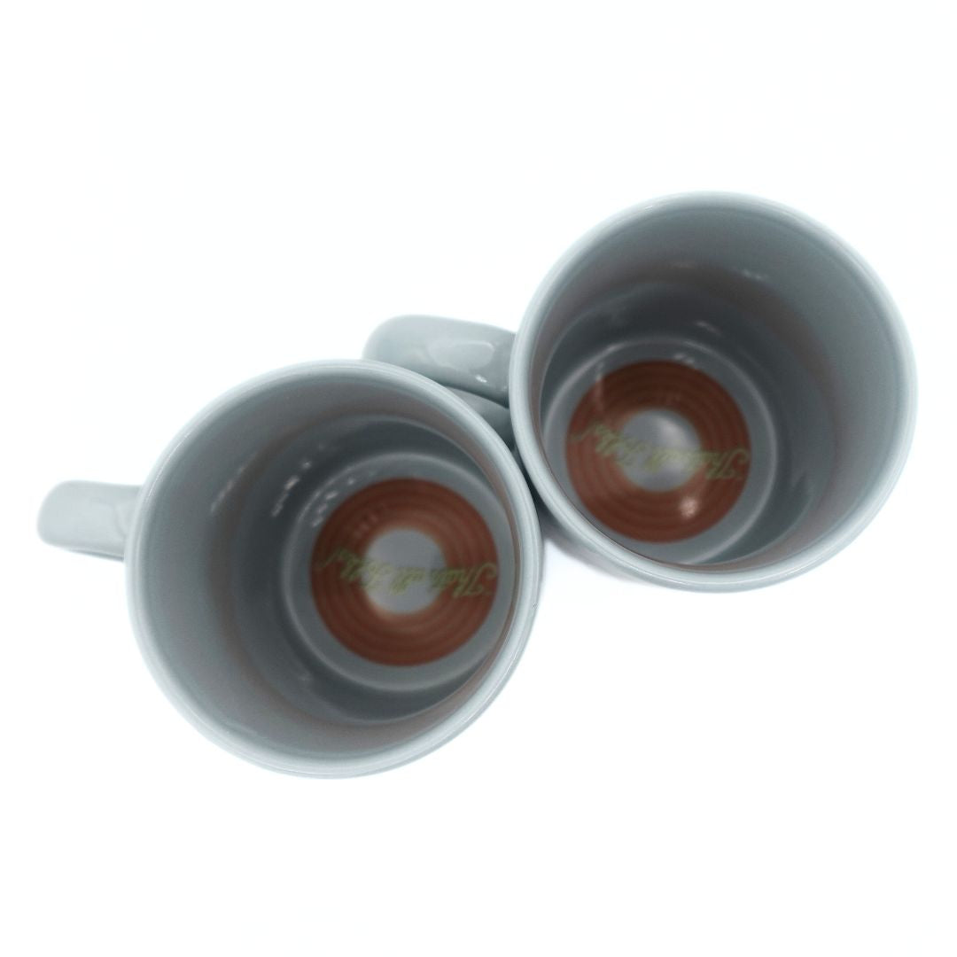 Inside two 90s Bugs Bunny mugs with That's All Folks! illustrated on the bottom