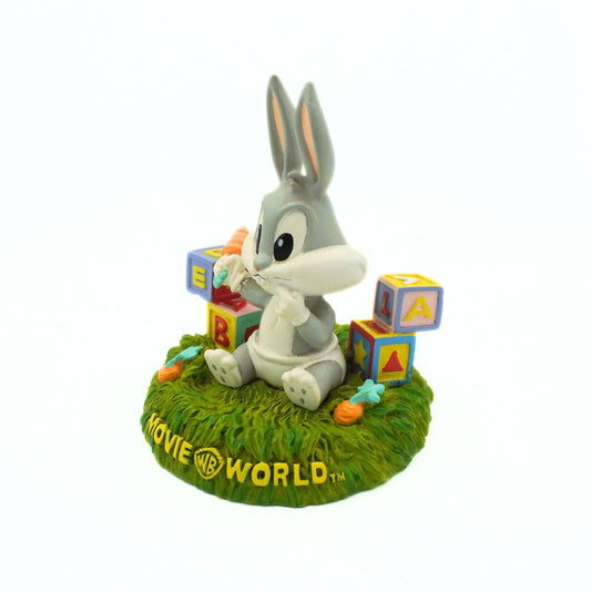 Figurine of a cartoon character with colorful blocks on a grassy base, featuring 'Movie & TV World' branding.