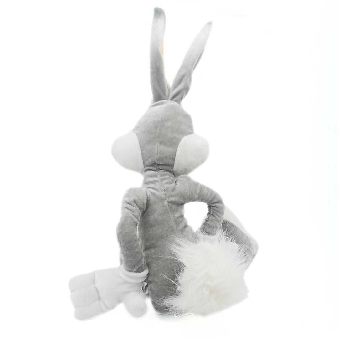 Grey and white Bugs Bunny plush toy with a velour-like fabrication and a hands-on-hips pose with a fluffy white tale