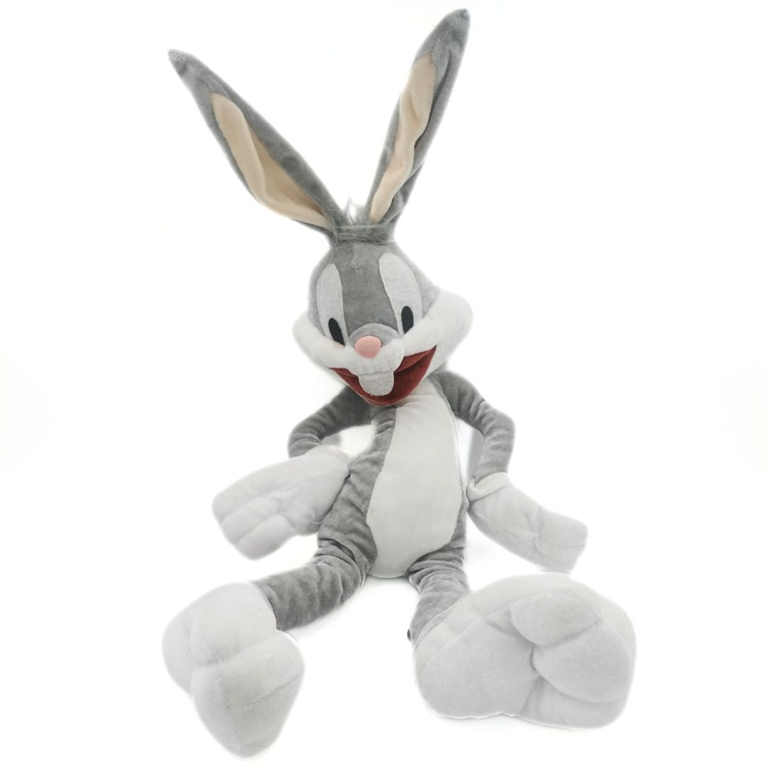 Grey and white Bugs Bunny plush toy with a velour-like fabrication and a hands-on-hips pose