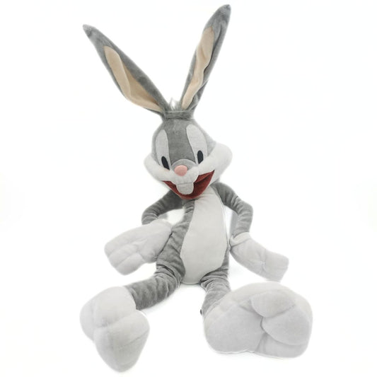 Grey and white Bugs Bunny plush toy with a velour-like fabrication and a hands-on-hips pose