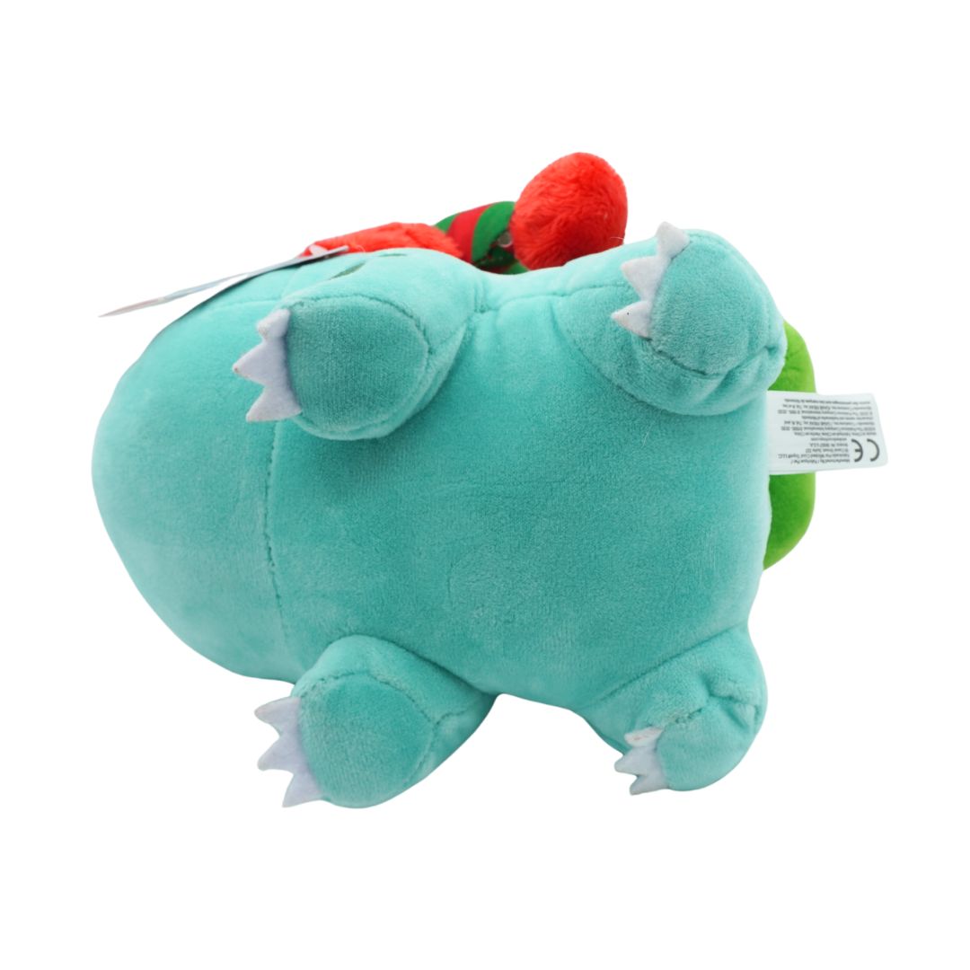 Plush toy with a green body and red flower on a white background