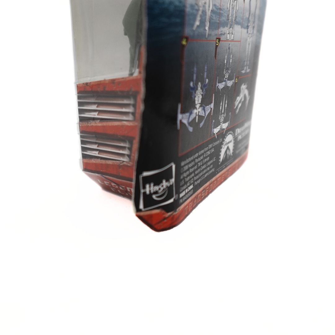 Bending damage to the cardback on a 2006 Transformers Decepticon figurine