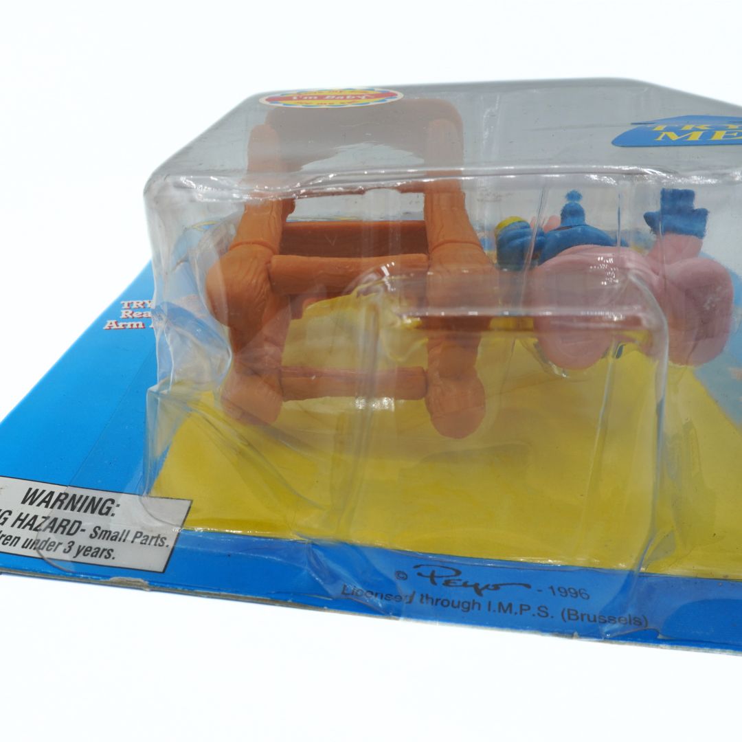 Toy figure in packaging with warning label on a white background