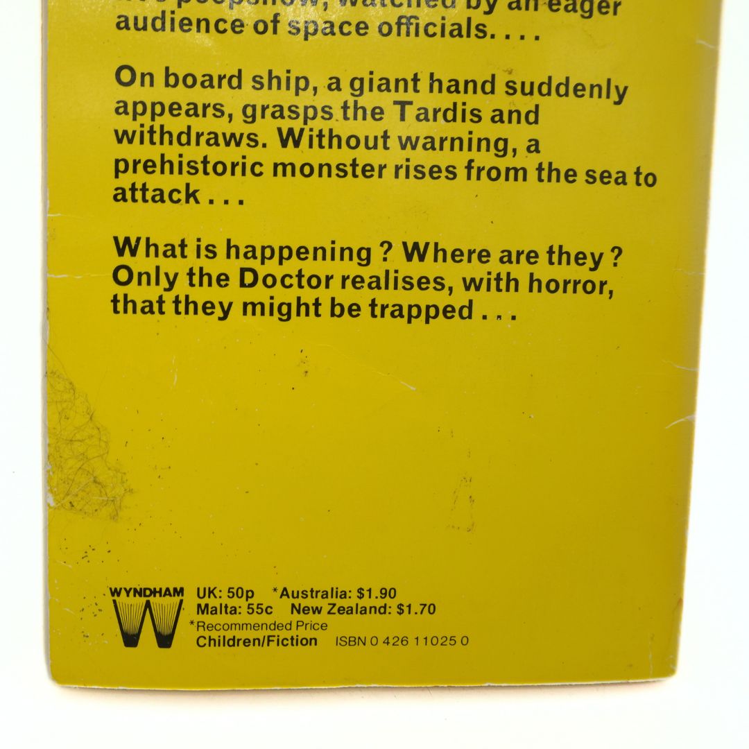 Back cover of a book with text and Wyndham logo on a yellow background