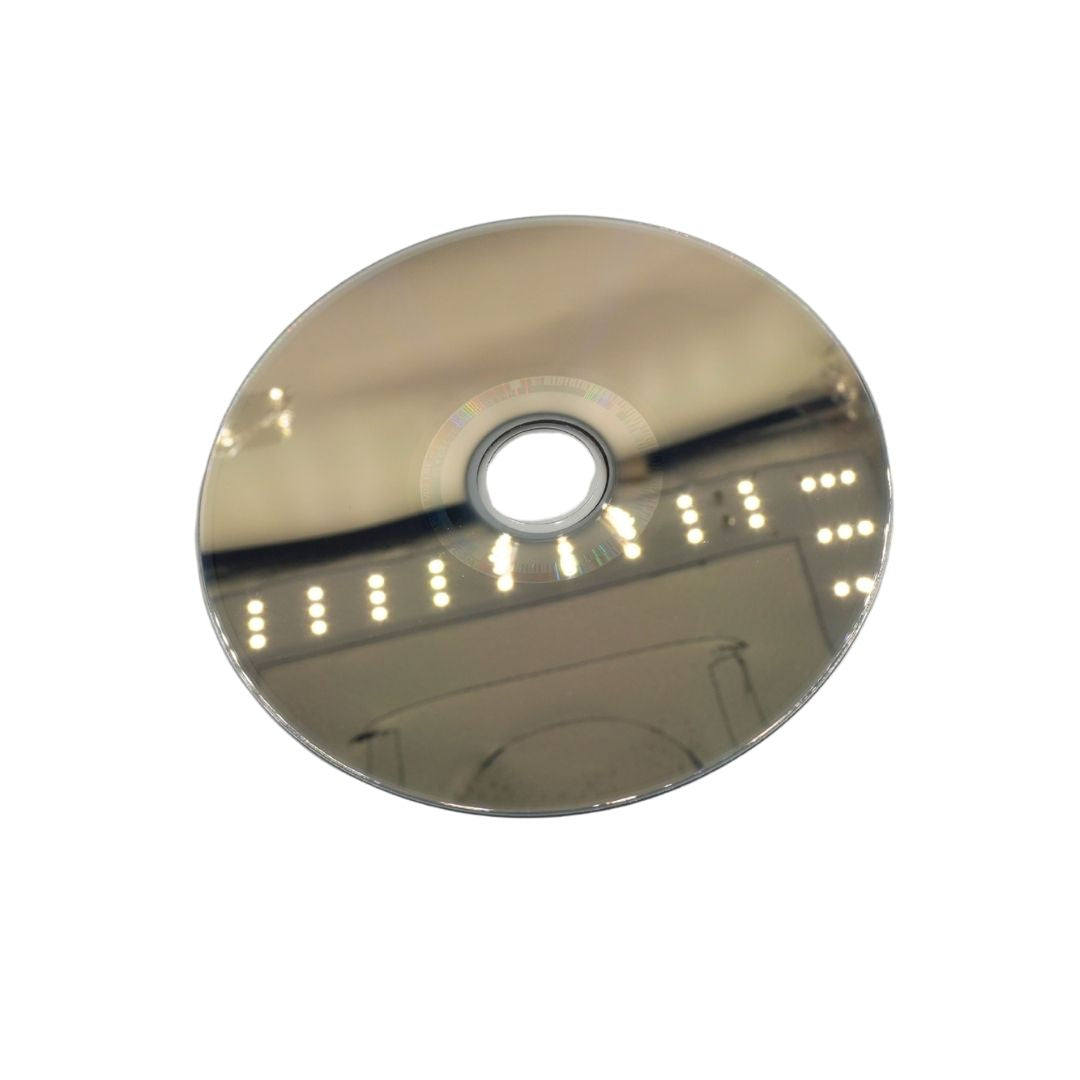 A round, highly polished chrome mirror with a central cutout, reflecting an indoor ceiling with light fixtures, isolated on a white background.