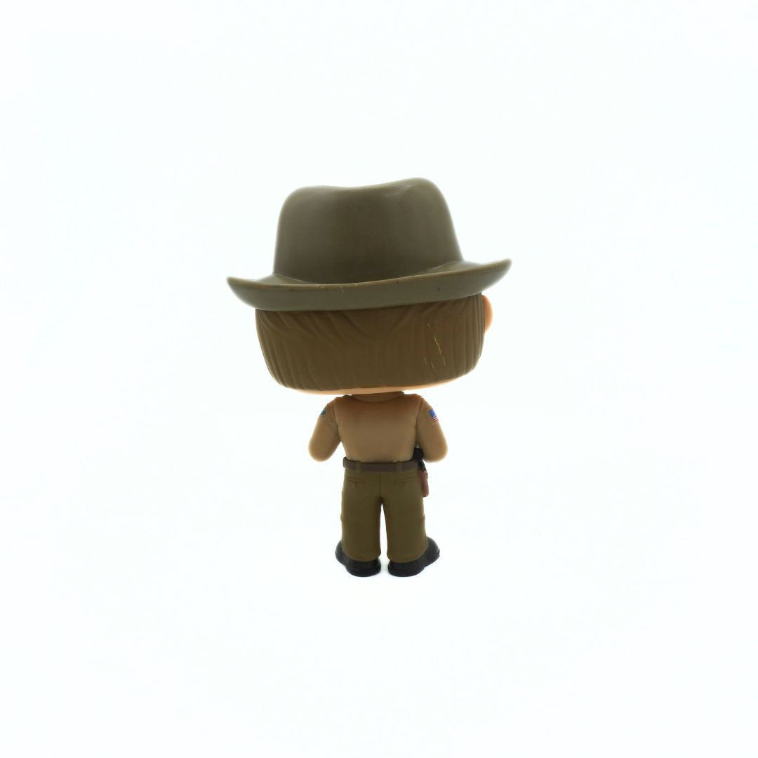 Figurine wearing a brown hat and pants on a white background