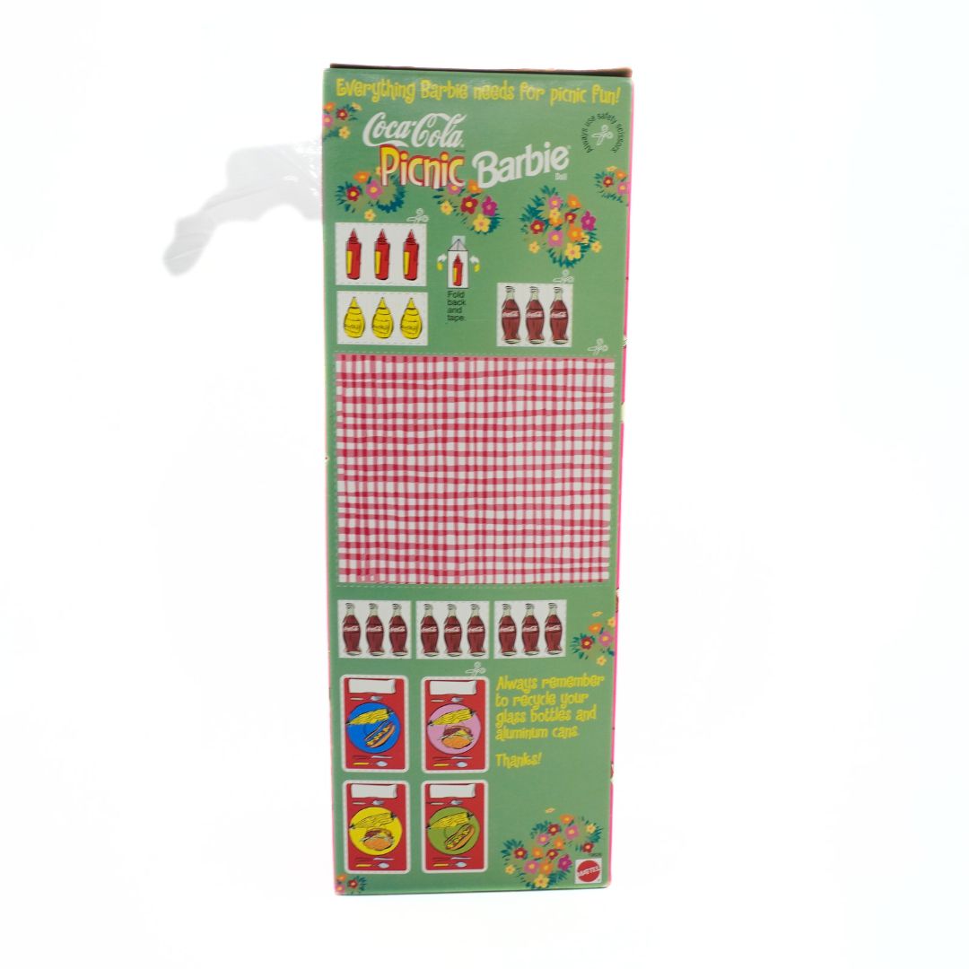 Packaging for a Coca-Cola Picnic Barbie set with green background and red checkered pattern.