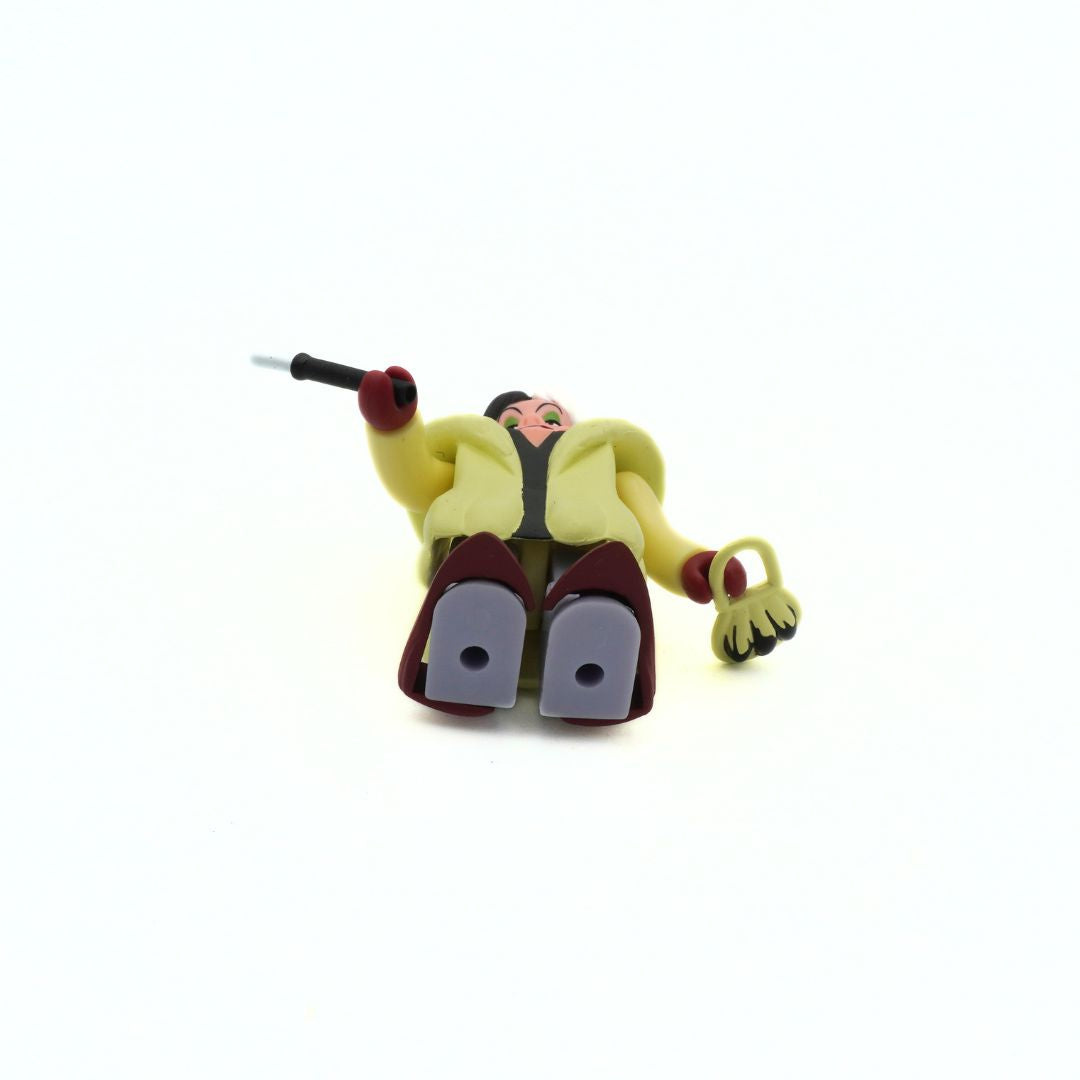 Vintage Disney Kubrick Cruella Deville mini figurine in a light yellow coat with red accessories seen from the underside