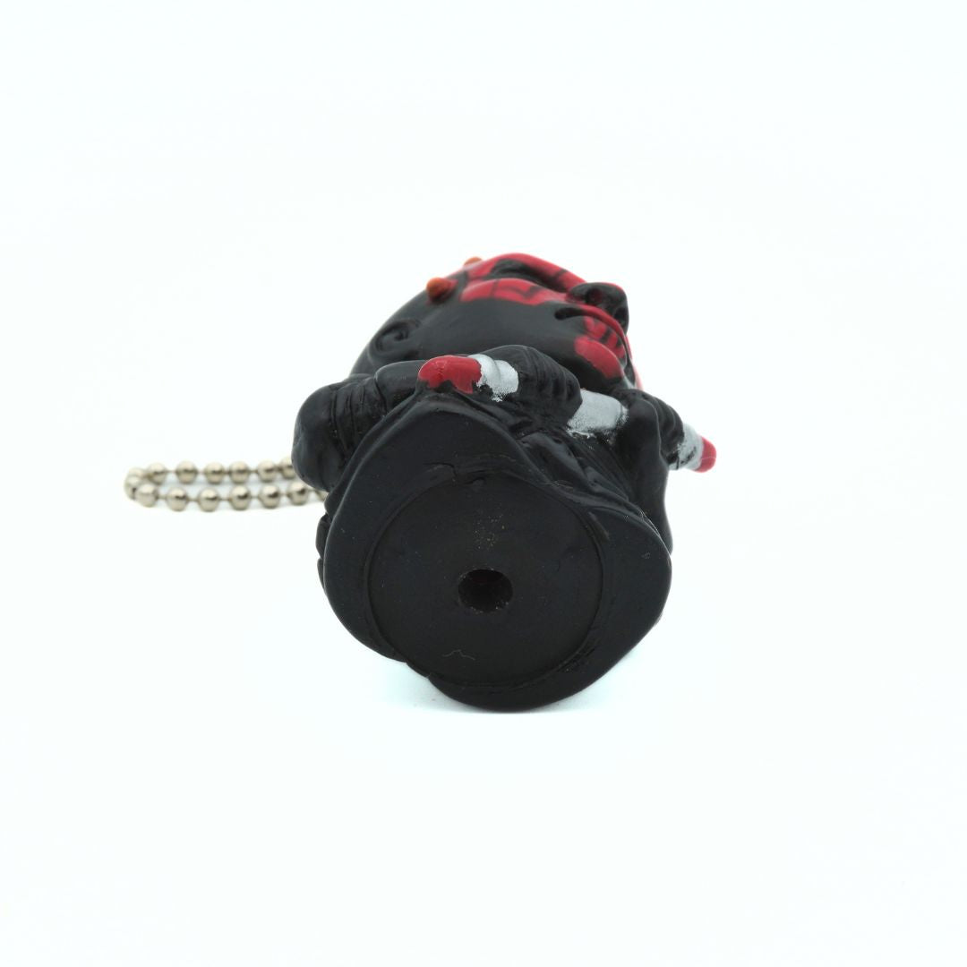 Underside of a vintage Star Wars Darth Maul keychain holding his dual ended lightsaber