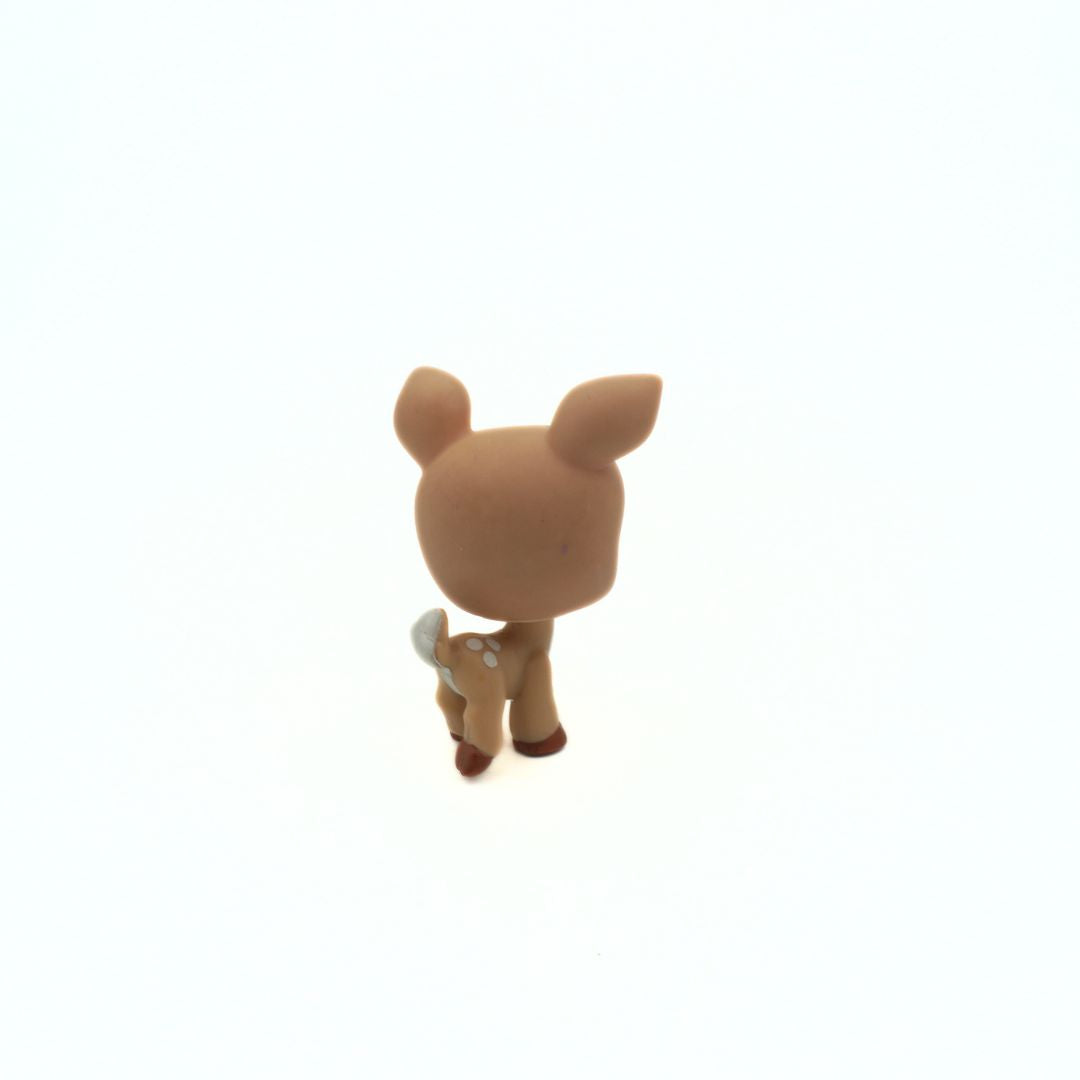 Small brown deer figurine on a white background