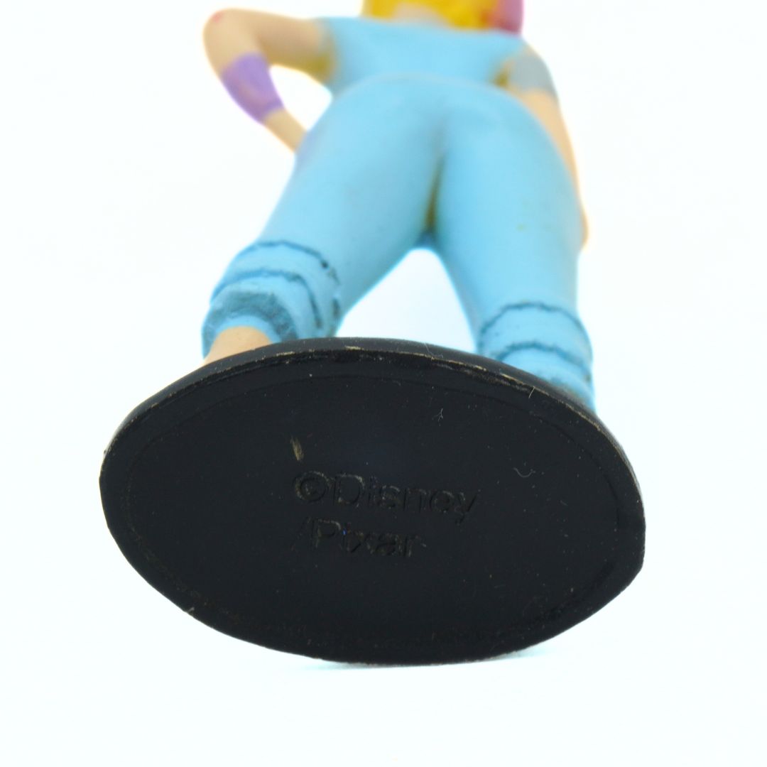 Close-up of a character figurine with a black base featuring 'Disney' branding on a white background.
