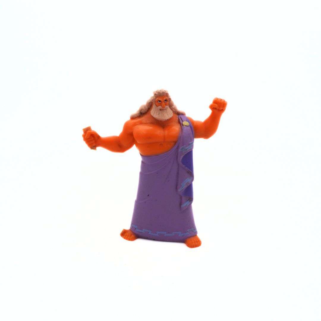 Toy figure of a muscular character with a purple garment on a white background